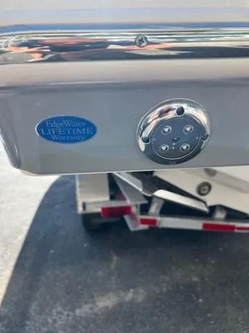 Slide: The Image of 2024 Edgewater 340CC boat with lifetime warranty badge, displayed on a trailer. - 29