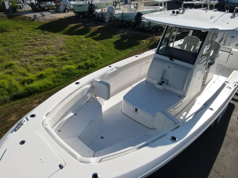 Slide: The Image of 2024 Edgewater 340CC boat with spacious deck and modern design, docked outdoors. - 32