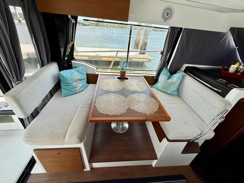 Slide: The Image of Interior of 2022 Jeanneau NC 1095 Coupe with cozy seating and table. - 15