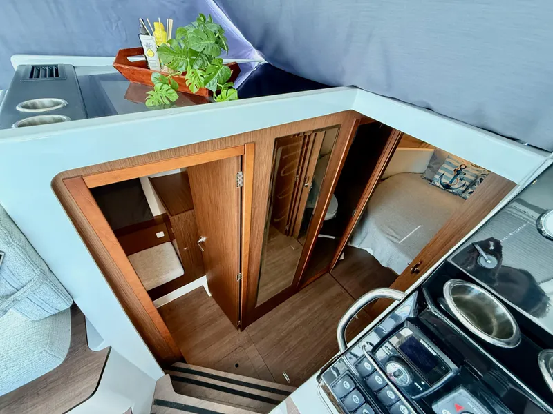 Slide: The Image of Interior view of 2022 Jeanneau NC 1095 Coupe, featuring wood finishes and modern design. - 17