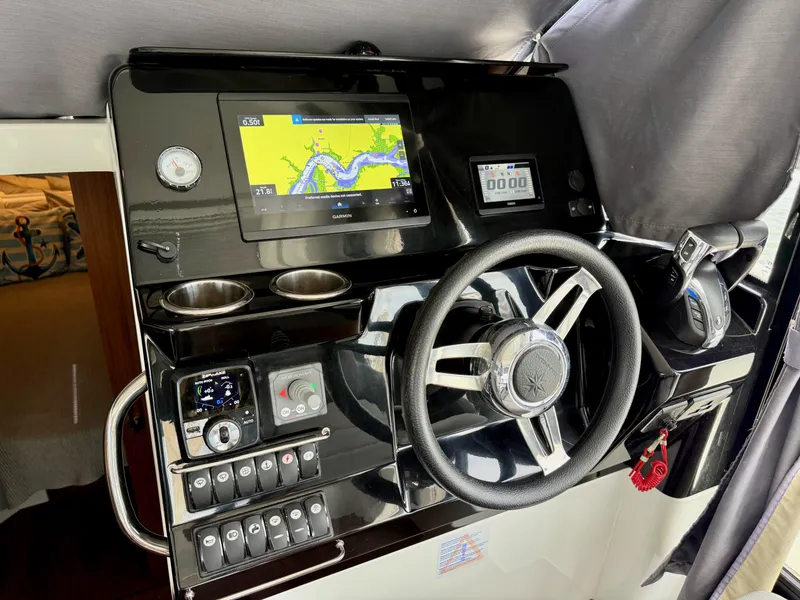 Slide: The Image of 2022 Jeanneau NC 1095 Coupe helm with navigation display and controls. - 20