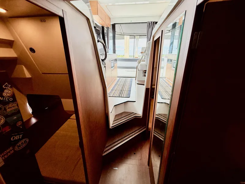 Slide: The Image of Interior view of 2022 Jeanneau NC 1095 Coupe boat, featuring modern design and wood finishes. - 22