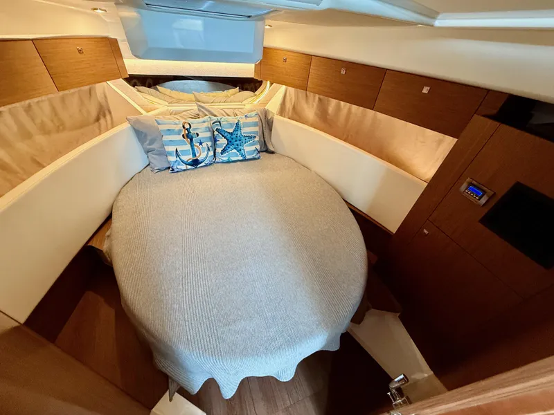 Slide: The Image of Cozy cabin interior of 2022 Jeanneau NC 1095 Coupe with nautical-themed pillows. - 23