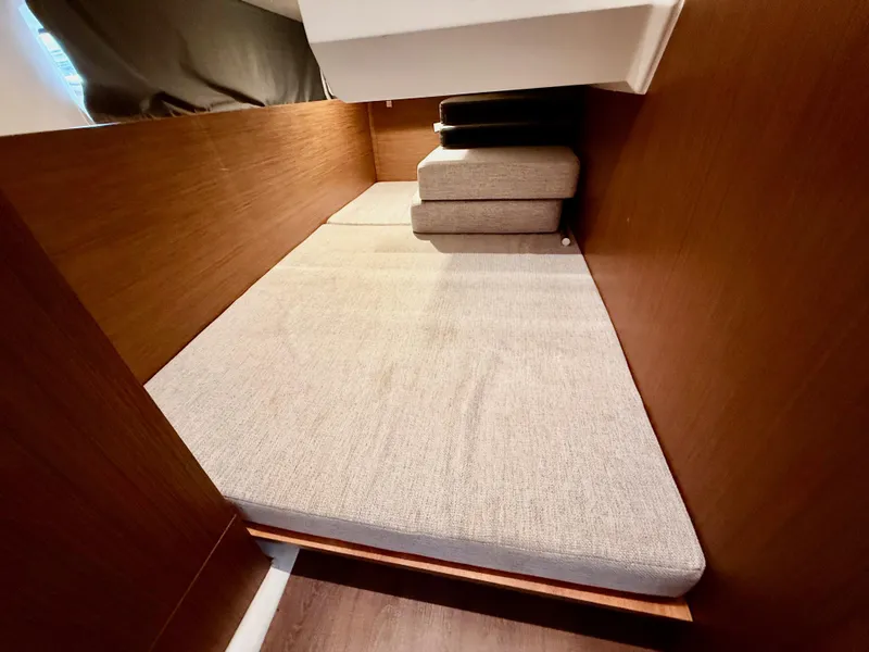 Slide: The Image of Interior cabin of 2022 Jeanneau NC 1095 Coupe with cushioned seating. - 25