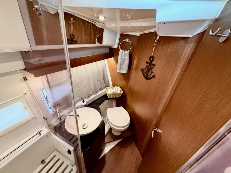 Slide: The Image of Bathroom interior of 2022 Jeanneau NC 1095 Coupe, featuring modern fixtures and wood accents. - 26