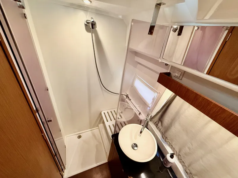 Slide: The Image of 2022 Jeanneau NC 1095 Coupe bathroom with shower, sink, and modern fixtures. - 28
