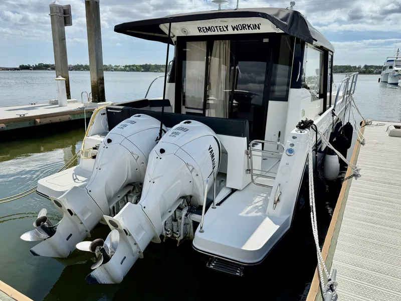 Slide: The Image of 2022 Jeanneau NC 1095 Coupe docked with twin outboard engines. - 3