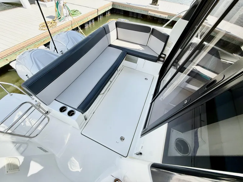 Slide: The Image of 2022 Jeanneau NC 1095 Coupe boat with spacious seating area and sleek design. - 5