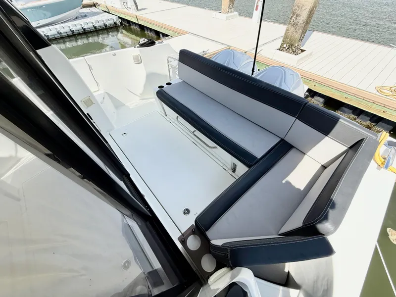 Slide: The Image of 2022 Jeanneau NC 1095 Coupe boat with sleek seating area at the dock. - 6