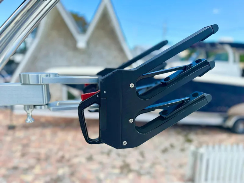 Slide: The Image of 2023 MasterCraft NXT24 boat accessory, close-up of a black metal component against a blurred background. - 11