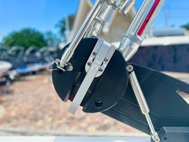 Slide: The Image of Close-up of 2023 MasterCraft NXT24 boat component with metal fittings and hydraulic system. - 12