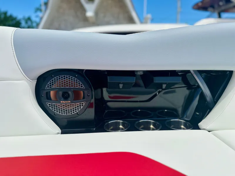 Slide: The Image of 2023 MasterCraft NXT24 boat interior with Klipsch speaker and cup holders. - 13