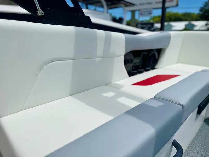 Slide: The Image of 2023 MasterCraft NXT24 boat interior with white and red seating. - 16