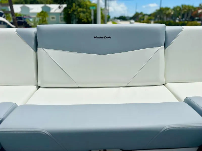 Slide: The Image of 2023 MasterCraft NXT24 boat seat with gray and white upholstery. - 18