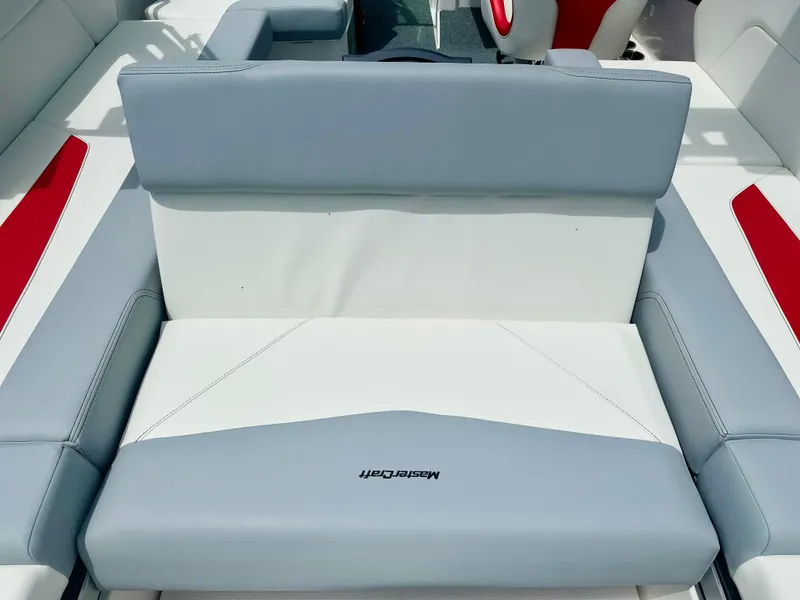 Slide: The Image of 2023 MasterCraft NXT24 boat interior with gray and white seating. - 19