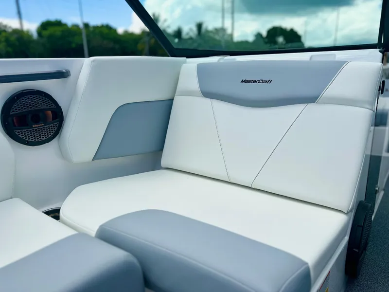 Slide: The Image of 2023 MasterCraft NXT24 boat interior with white and gray seating. - 21