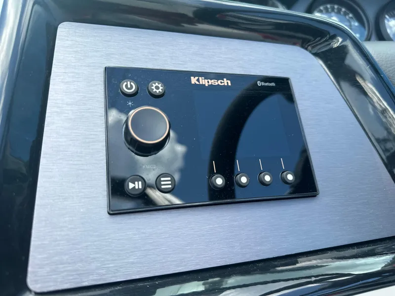 Slide: The Image of Control panel of 2023 MasterCraft NXT24 boat featuring a Klipsch audio system. - 24
