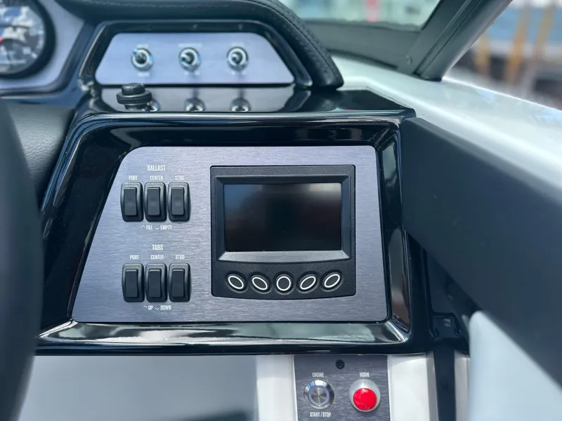 Slide: The Image of 2023 MasterCraft NXT24 dashboard with control panel and digital display. - 28