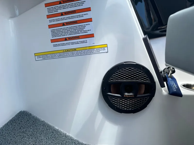 Slide: The Image of 2023 MasterCraft NXT24 interior with speaker and warning labels. - 30