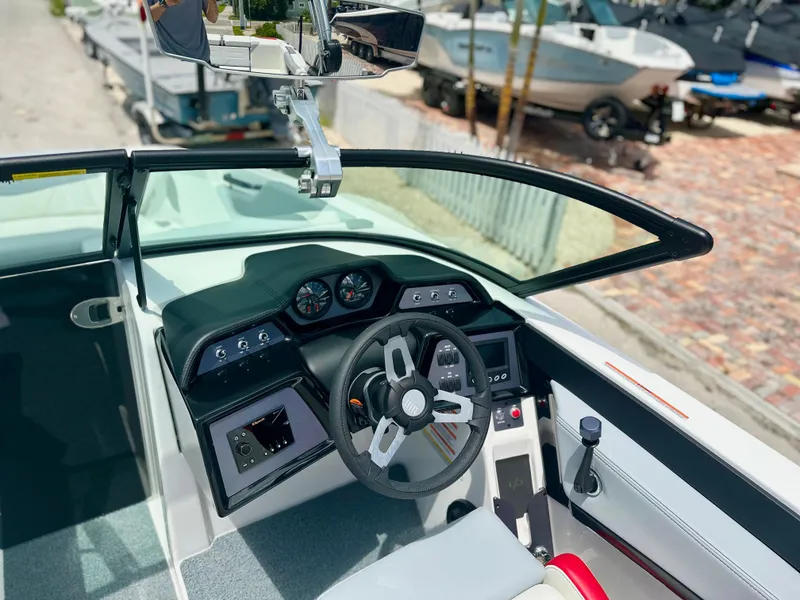 Slide: The Image of 2023 MasterCraft NXT24 boat cockpit with modern steering and dashboard controls. - 36