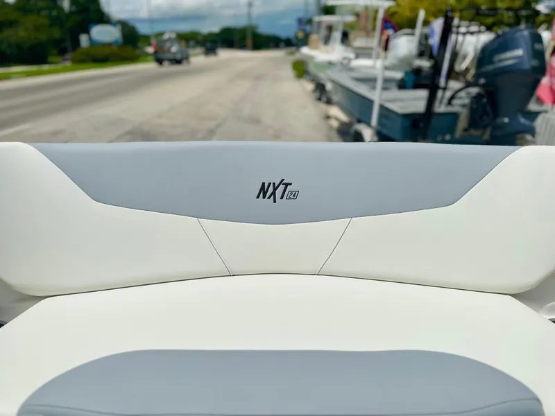 Slide: The Image of 2023 MasterCraft NXT24 boat seat with logo, parked near a road. - 38