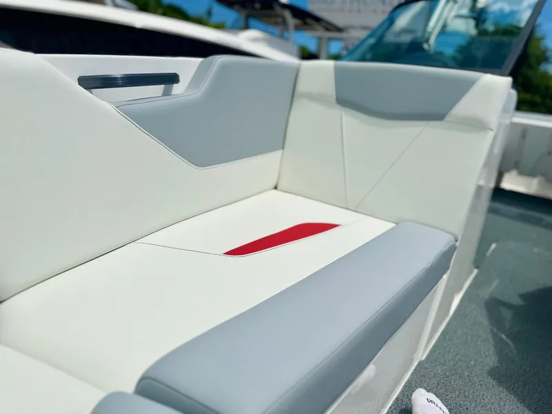 Slide: The Image of 2023 MasterCraft NXT24 boat interior with white and gray seating, featuring a red accent. - 39