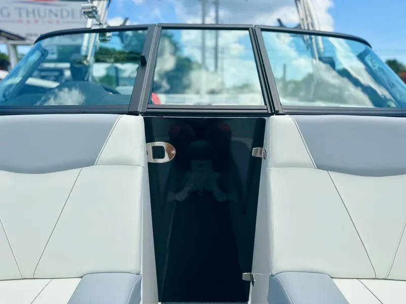Slide: The Image of 2023 MasterCraft NXT24 boat interior with sleek seating and glass windshield. - 41