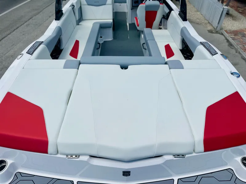 Slide: The Image of 2023 MasterCraft NXT24 boat interior with white and red seating, showcasing spacious design. - 6
