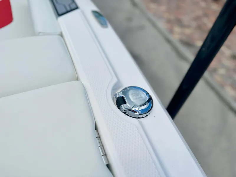Slide: The Image of 2023 MasterCraft NXT24 boat detail showing a chrome fixture on white upholstery. - 7