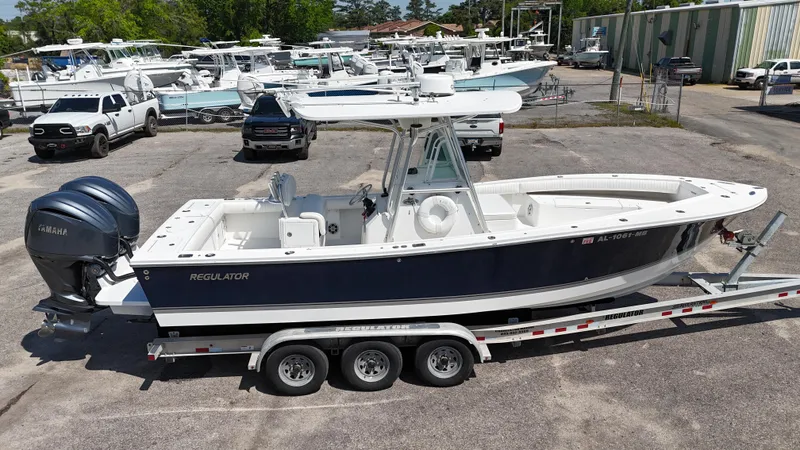 Slide: The Image of 2007 Regulator 26 Forward Seating boat on trailer, parked in marina lot. - 0
