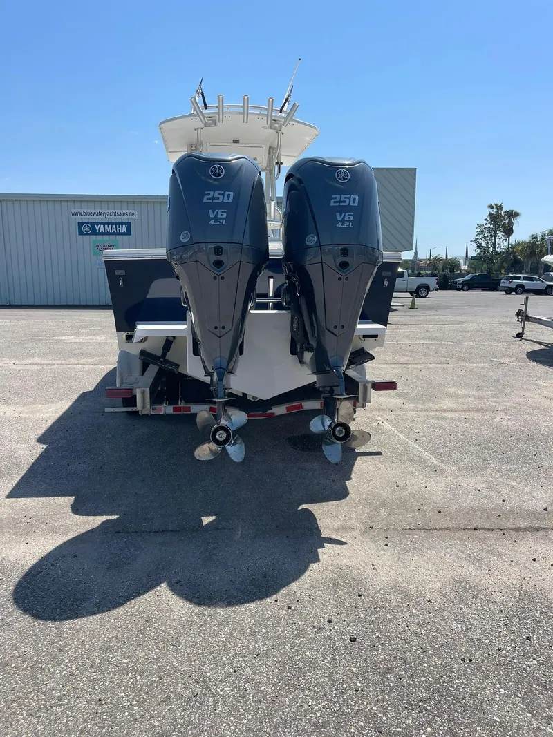 Slide: The Image of 2007 Regulator 26 Forward Seating boat with twin Yamaha 250 engines, parked outdoors. - 16