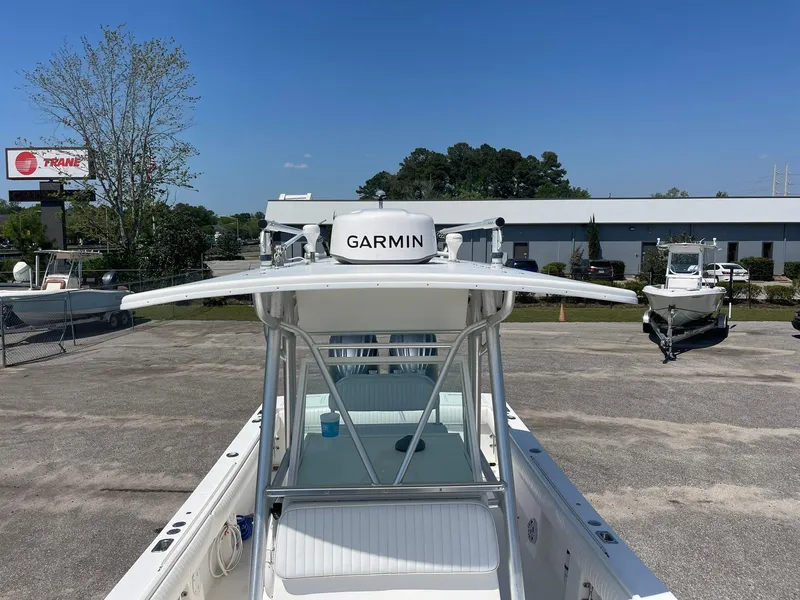 Slide: The Image of 2007 Regulator 26 Forward Seating boat with Garmin equipment, parked outdoors under clear blue sky. - 18