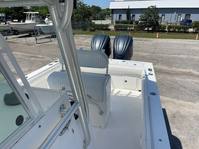 Slide: The Image of 2007 Regulator 26 Forward Seating boat with dual engines, parked outdoors. - 19