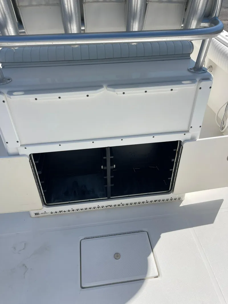 Slide: The Image of 2007 Regulator 26 Forward Seating boat storage compartment and rod holders. - 20