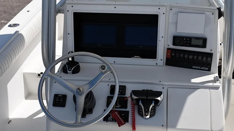 Slide: The Image of 2007 Regulator 26 Forward Seating boat console with steering wheel and controls. - 22
