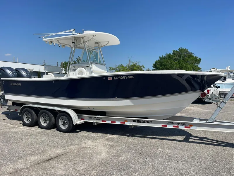 Slide: The Image of 2007 Regulator 26 Forward Seating boat on a trailer, featuring a sleek navy and white design. - 4