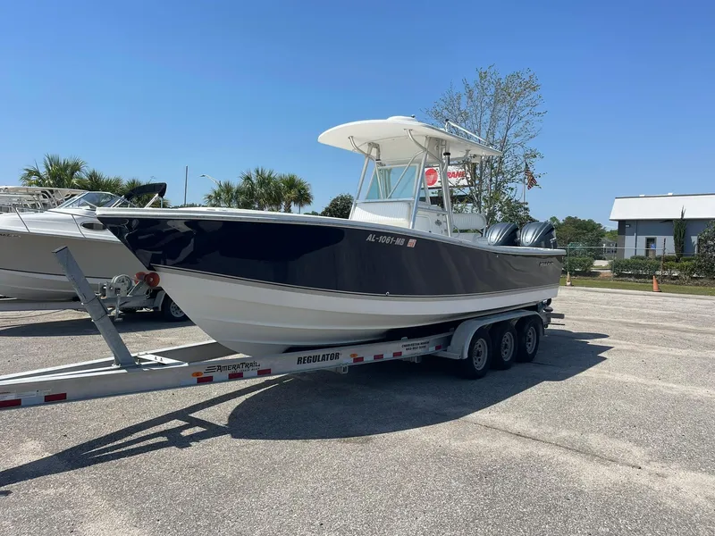 Slide: The Image of 2007 Regulator 26 Forward Seating boat on trailer in sunny parking lot. - 5