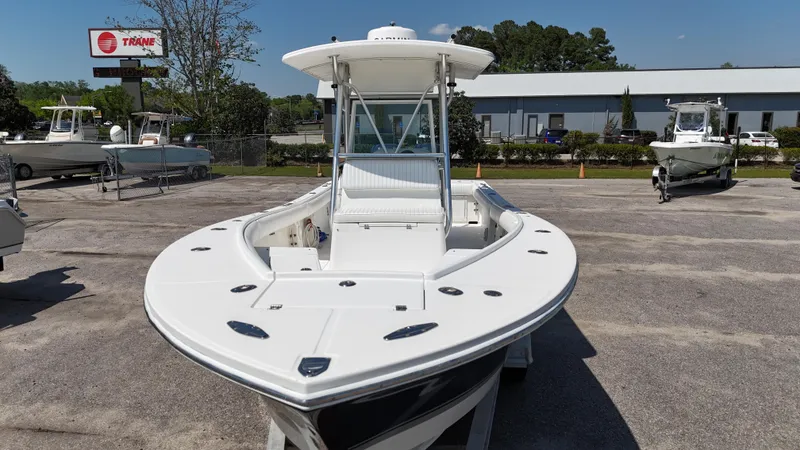 Slide: The Image of 2007 Regulator 26 Forward Seating boat in a dealership lot, sunny day. - 6