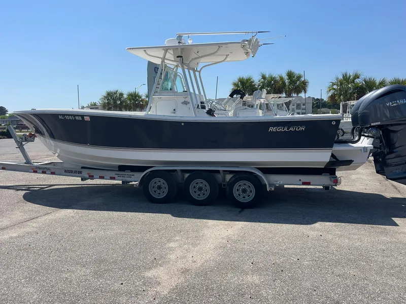 Slide: The Image of 2007 Regulator 26 Forward Seating boat on a trailer, parked outdoors. - 8