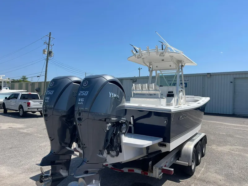 Slide: The Image of 2007 Regulator 26 Forward Seating boat with twin Yamaha engines on a trailer. - 9