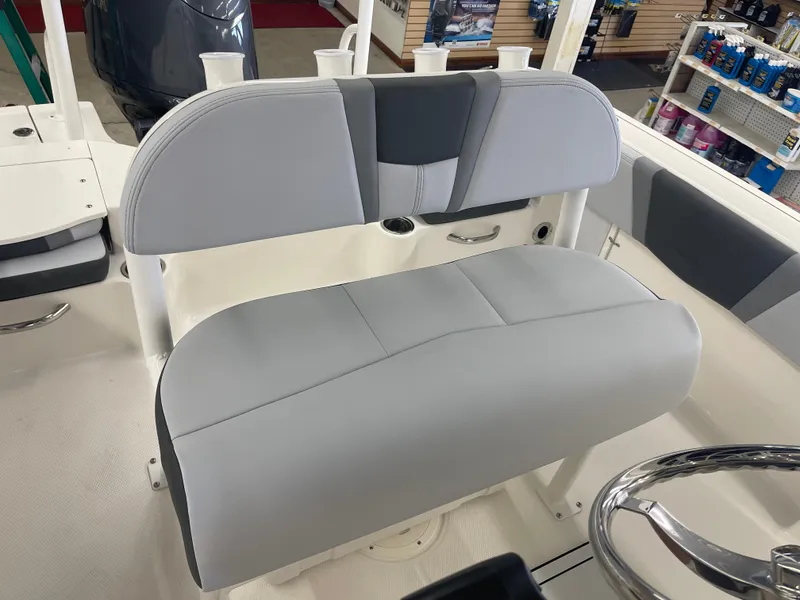 Slide: The Image of 2025 Robalo R180 Center Console boat interior with gray seating and steering wheel. - 10