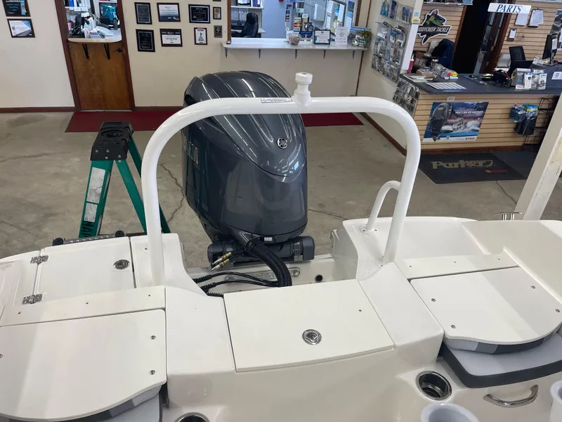 Slide: The Image of 2025 Robalo R180 Center Console boat with Yamaha outboard motor in showroom. - 12