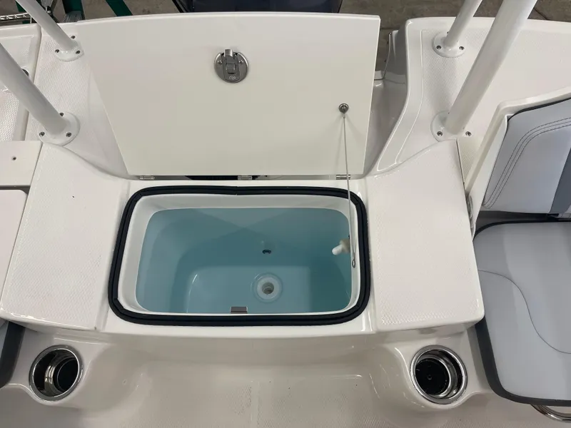 Slide: The Image of 2025 Robalo R180 Center Console boat with open storage compartment and seating. - 13