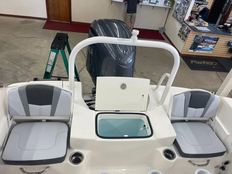 Slide: The Image of 2025 Robalo R180 Center Console boat interior with seating and engine view. - 14