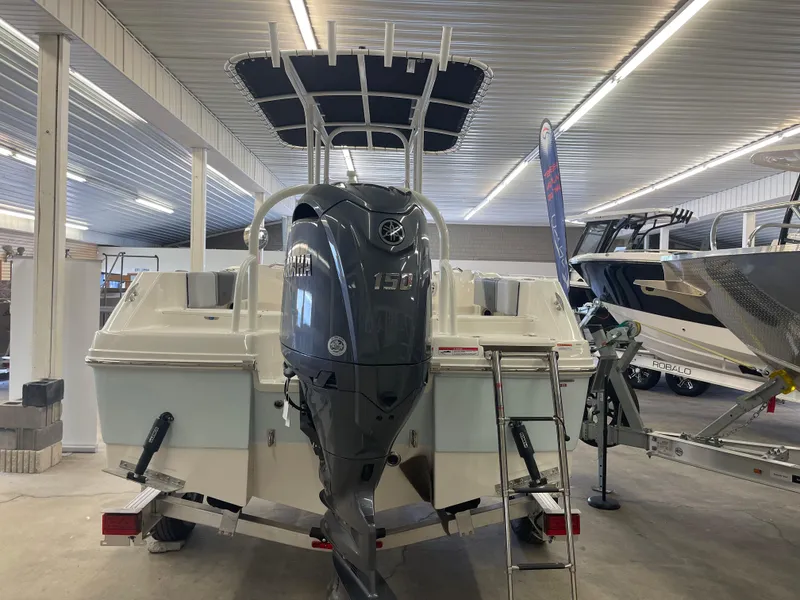 Slide: The Image of 2025 Robalo R180 Center Console boat with Yamaha outboard motor in showroom. - 15