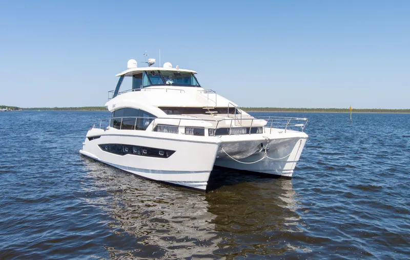 Slide: The Image of Aquila 54 Yacht 2022 cruising on calm waters under clear blue skies. - 0