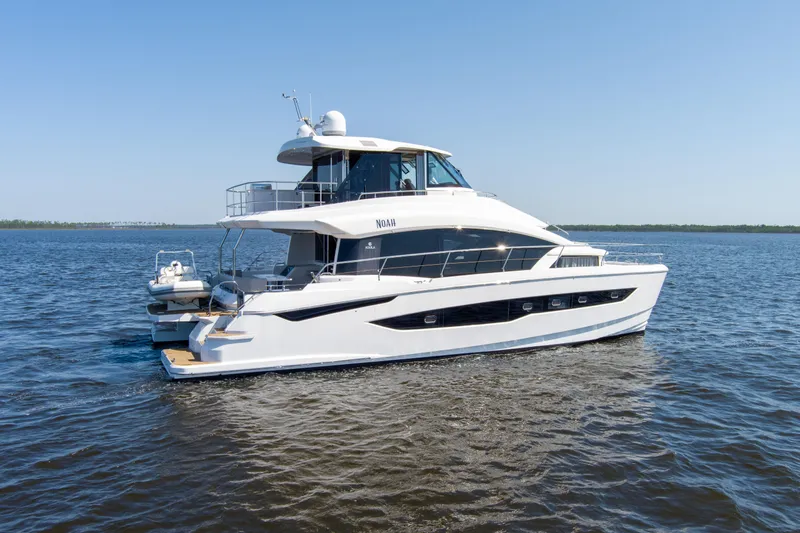 Slide: The Image of Aquila 54 Yacht 2022 cruising on open water under clear blue skies. - 1