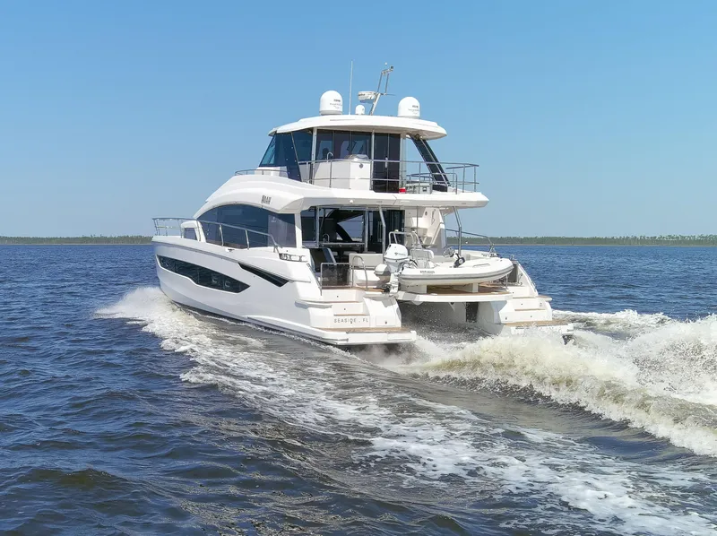 Slide: The Image of Aquila 54 Yacht 2022 cruising on open water under clear blue sky. - 10