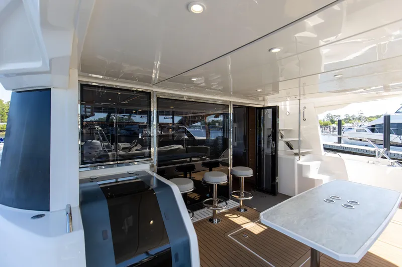 Slide: The Image of Aquila 54 Yacht 2022 interior with modern seating and sleek design. - 11