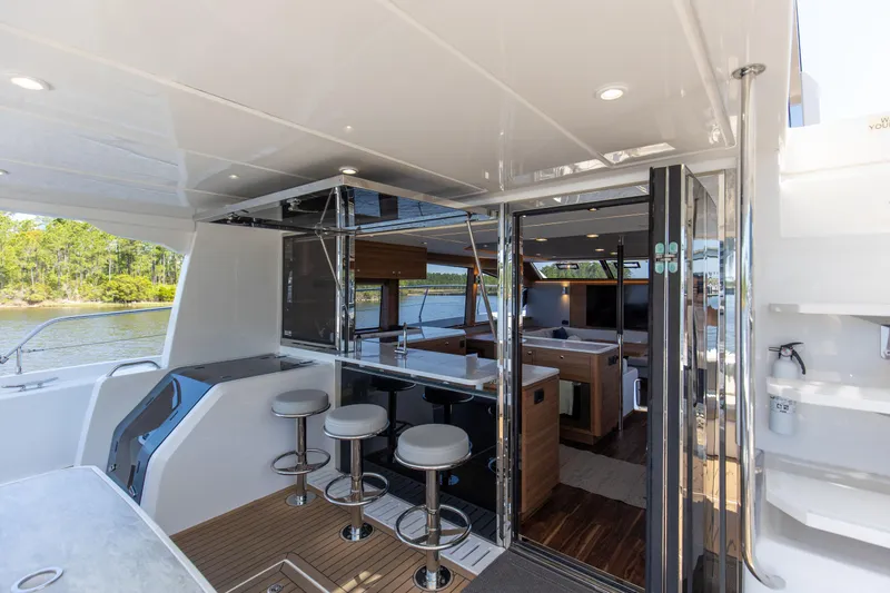 Slide: The Image of Luxurious 2022 Aquila 54 Yacht interior with bar stools and modern design. - 12